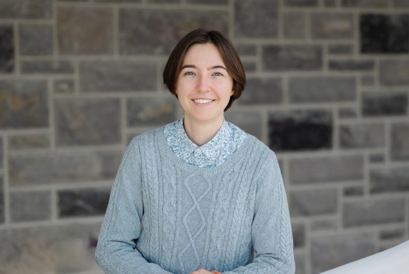 Headshot of Elena Conway in front of a Hokie stone wall.