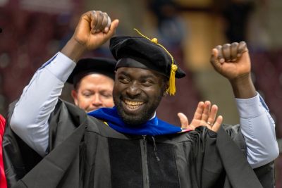 a graduate celebrates