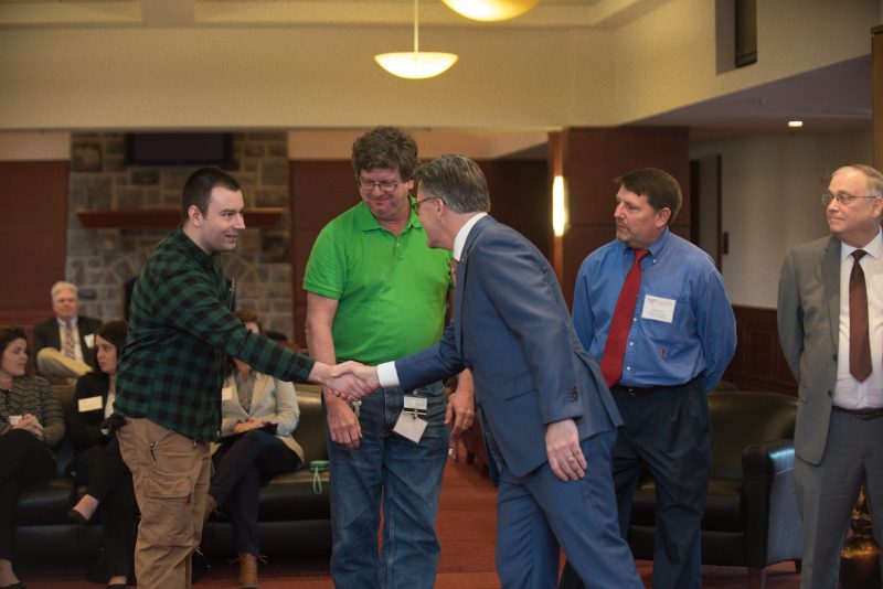 President Sands shakes hands with award recipient at President's Award Ceremony
