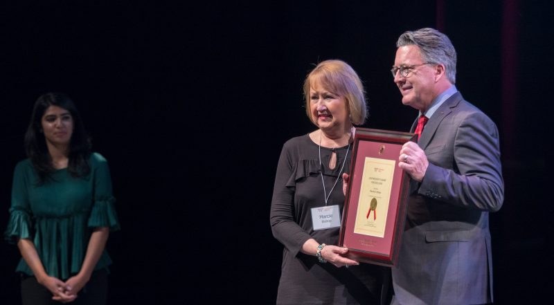 Tim Sands (right) poses with Marcie Bishop, a recipient of the President's Award for Excellence.