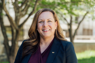 Portrait of Saskia van de Gevel outside wearing a suit with a VT pin.