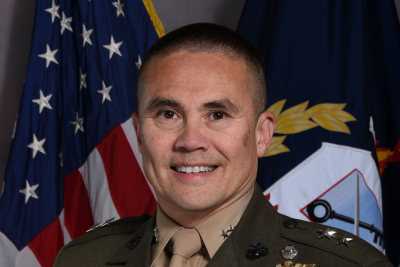 Headshot of Gen. Dwayne Edwards in uniform and standing in front of flags.