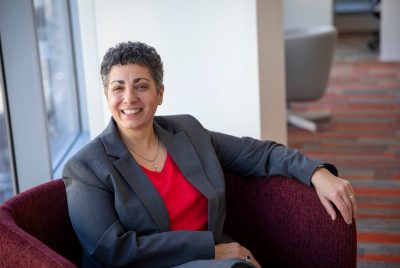 Photo of Laura Belmonte, dean of the College of Liberal Arts and Human Sciences, posing for a photo and smiling.