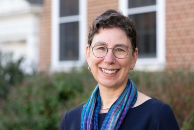 Photo of Dean Aimee Surprenant standing outside of the Graduate Life Center at Virginia Tech