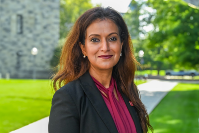 Headshot of Saonee Sarker in a suit and standing outside. 