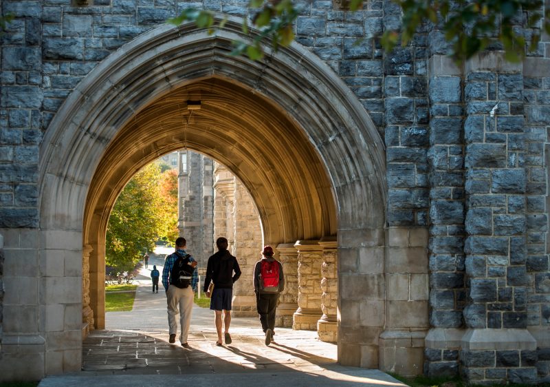 Group of students walking under archway on Virginia Tech's campus